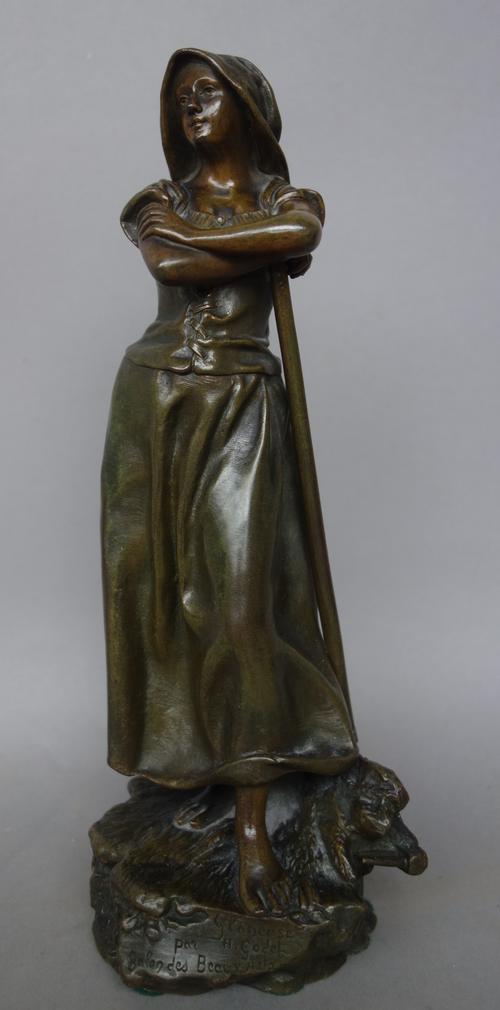 A French patinated bronze figure by Henri Godet 'Glaneuse', late 19th century, modelled as a female harvester leaning on her rake, signed and titled,
