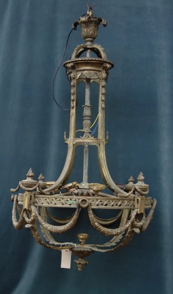 A gilt bronze nine light chandelier, 19th century, with acanthus cast surmount over a circular open cage frame, enclosing nine light fitments (lacking