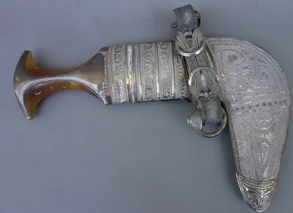 A Middle Eastern jambia with white metal mounts, and a South East Asian white metal opium pipe and pouch, (2).