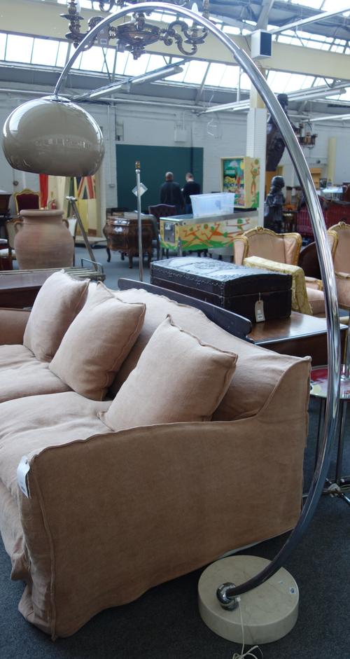 A 1970s chrome floor lamp in the manner of Castiglioni, the circular marble base supporting a curved chrome stem, with plastic shade.