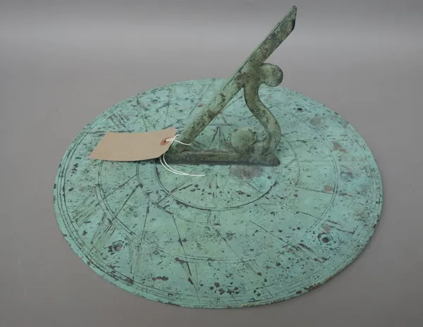An 18th century style patinated bronze sundial plate, 20th century, typical circular form with shaped central gnomon, 38cm diameter.