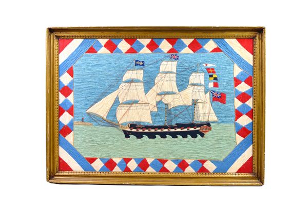 A woolwork ship picture, early 20th century, depicting a British war ship, fully rigged, polychrome colours, within a wide chequered border, framed an