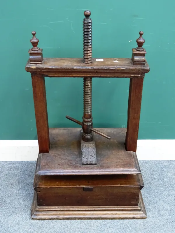 An 18th century and later oak table top book press, on plinth base, 59cm wide x 90cm high x 48cm deep.