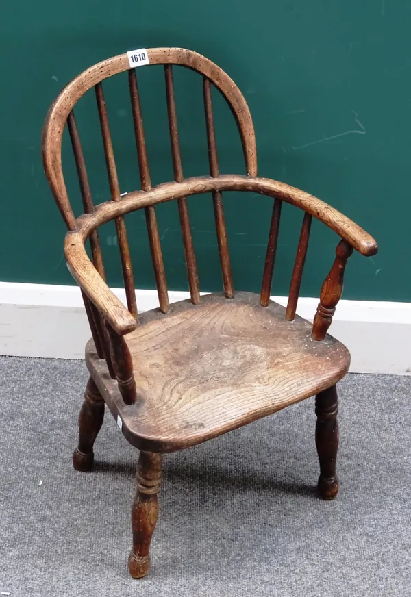 An early 19th century ash and elm child's Windsor chair, with solid seat and turned supports, 38cm wide x 63cm high.