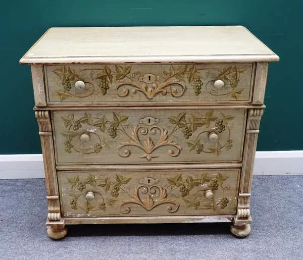 A 19th century later painted Continental pine three drawer chest, decorated with fruiting vines, on bun feet, 94cm wide x 84cm high x 53cm deep.