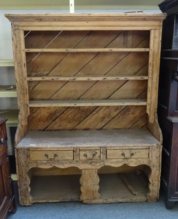 A 19th century Irish pine dresser, the enclosed three tier plate rack over three drawers, on silhouette supports united by pot board undertier, 147cm