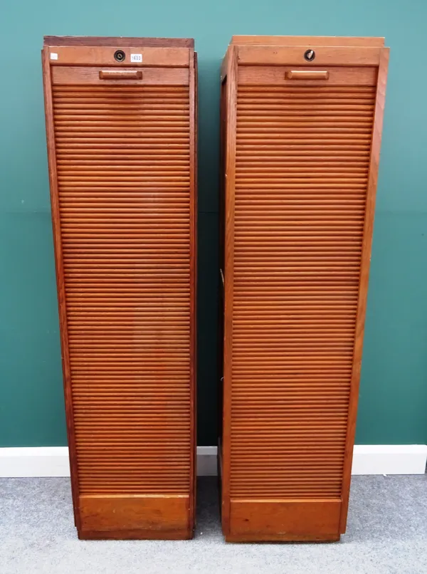 A pair of mid-20th century oak tambour fronted cabinets, on plinth bases, 47cm wide x 180cm high x 35cm deep, (2).
