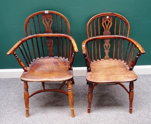 F.Walker Rockley; a near pair of George III yew and elm low back Windsor chairs, on turned supports, united by crinoline stretcher, each approximately