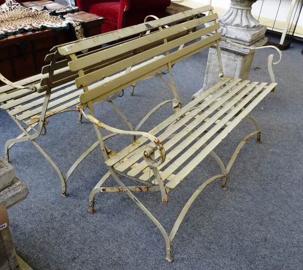 A pair of Regency style beige painted folding wrought iron benches, with slatted supports, 139cm wide x 88cm high (2).