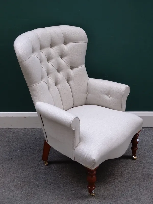 A modern button back easy armchair in the Victorian style, with serpentine seat, turned supports and dog tooth upholstery, 66cm wide x 90cm high.