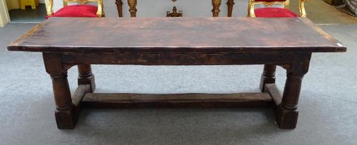 A made-up oak refectory table incorporating 17th century and later elements, the twin plank top on turned supports united by 'H' frame stretcher, 77cm