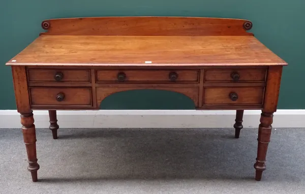 A George IV mahogany writing table, with five frieze drawers on tapering turned supports, 143cm wide x 87cm high x 64cm deep.