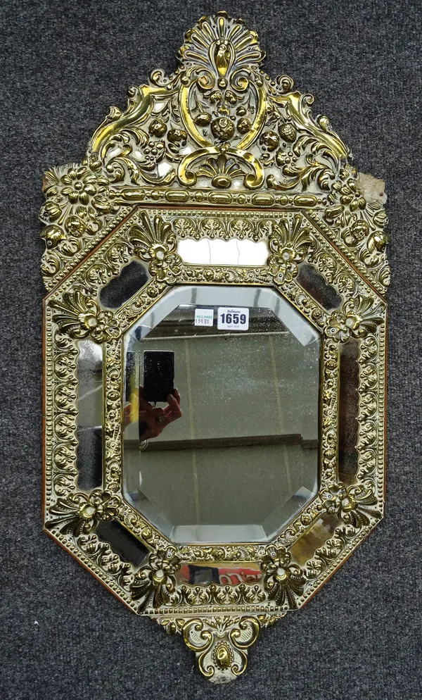 A 19th century Dutch brass repoussé marginal wall mirror, of compressed octagonal form, 38cm wide x 71cm high.