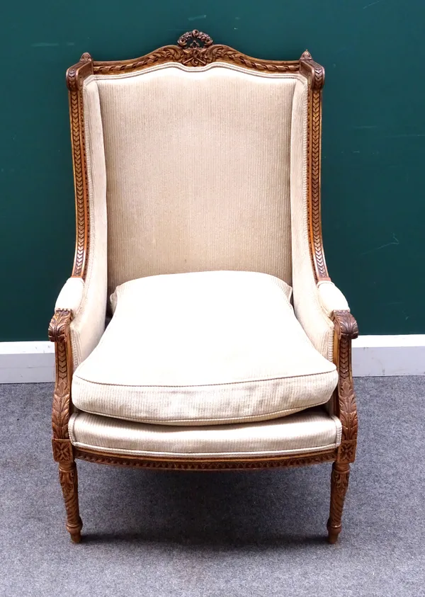 A Louis XV style gilt framed square wingback armchair, with bow seat on spiral fluted supports, 65cm wide x 109cm high.