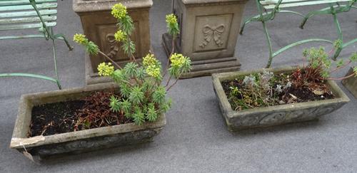 A set of four reconstituted stone rectangular planters, with scroll work bodies, each 73cm wide x 24cm high x 34cm deep, (4).
