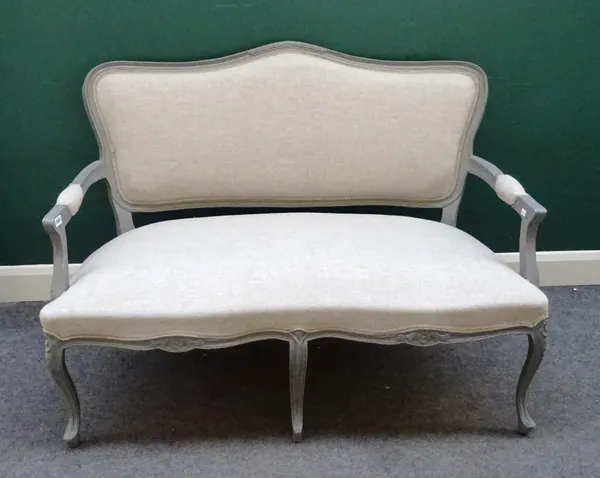 A Louis XV style open arm sofa, with double serpentine seat, on scroll supports, 128cm wide x 95cm high.