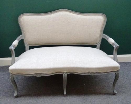 A Louis XV style open arm sofa, with double serpentine seat, on scroll supports, 128cm wide x 95cm high.
