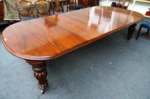 An early Victorian mahogany 'D' end dining table, on reeded baluster supports, with five extra fixed leaves, 148cm wide x 298cm long x 71cm high.