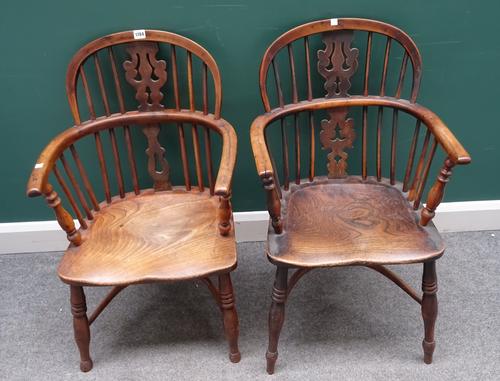 A near pair of George III yew and elm low back Windsor chairs, on turned supports, united by crinoline stretcher, each approximately 50cm wide x 87cm