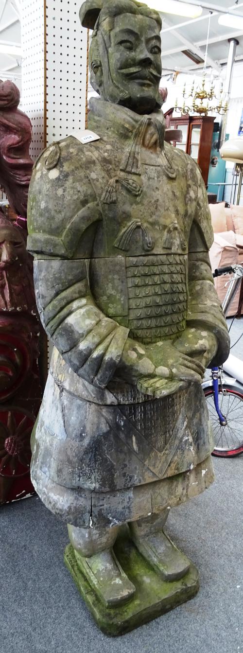 A reconstituted stone figure in the manner of one of Qin Shi Huang's tomb Terracotta Warriors, 60cm wide x 206cm high.