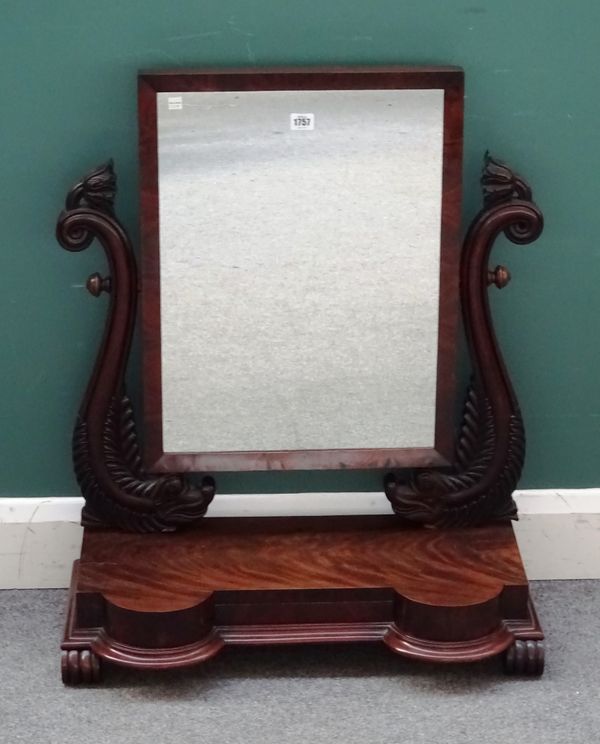 A Regency mahogany swing-frame toilet mirror with carved dolphin mounts on double bow front single drawer base, 68cm wide x 83cm high x 35cm deep.