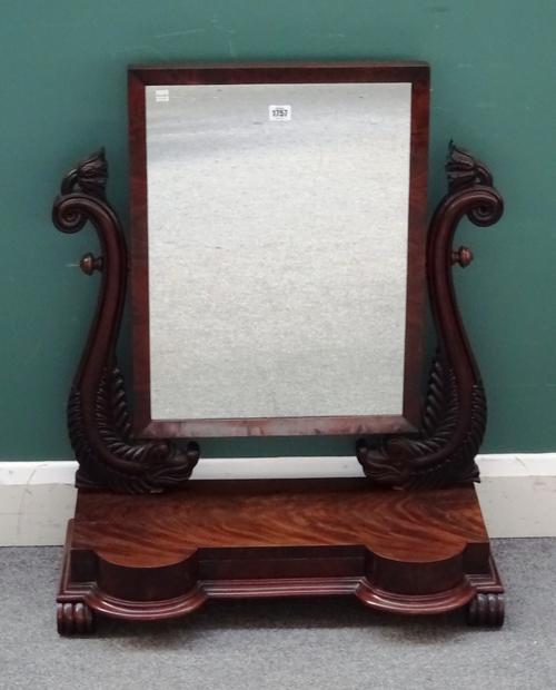 A Regency mahogany swing-frame toilet mirror with carved dolphin mounts on double bow front single drawer base, 68cm wide x 83cm high x 35cm deep.