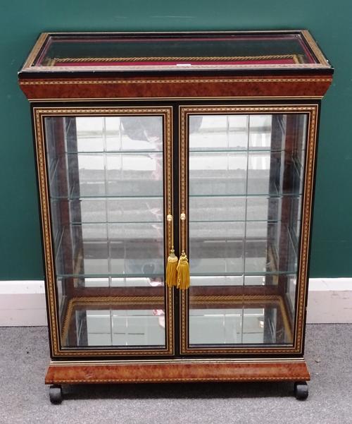 A 20th century figured walnut display case, with glazed hinged top over a pair of doors, 69cm wide x 89cm high x 36cm deep.