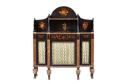 A Regency parcel gilt ebonised chiffonier, the shaped shelf back over single drawer and three grille doors, on turned supports, 99cm wide x 120cm high