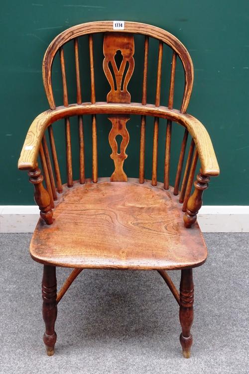 A George III ash and elm low back Windsor chair, on turned supports united by crinoline stretcher, 49cm wide x 88cm high.