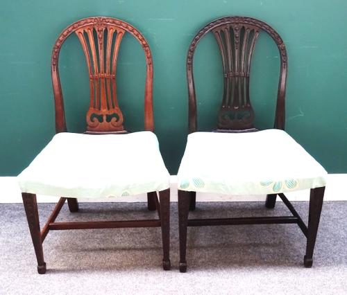 A set of ten Hepplewhite style hoop back dining chairs, 19th century, on bell flower carved tapering square supports, each 56cm wide x 93cm high, (10)