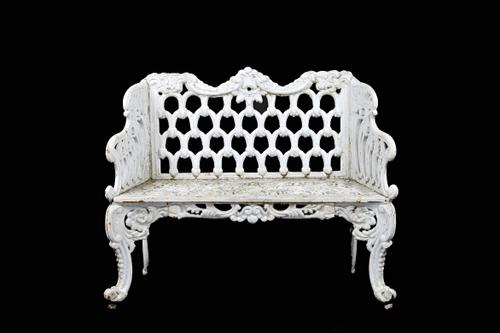 A pair of early 20th century white painted cast iron garden benches, each with interlaced back and scroll pierced seat, on scroll supports, 110cm wide