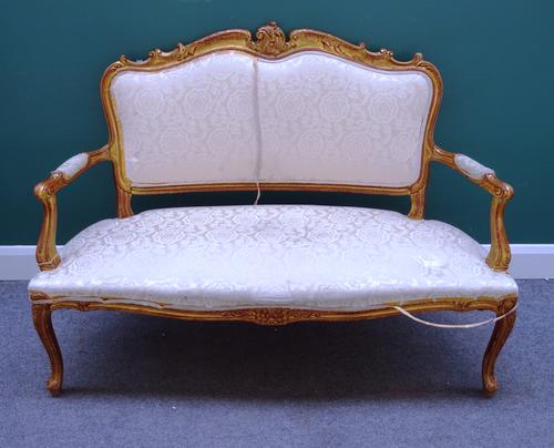 A Louis XV style gilt framed salon suite, to comprise; a sofa (135cm wide x 98cm high), a pair of open armchairs and four single chairs, each with ser