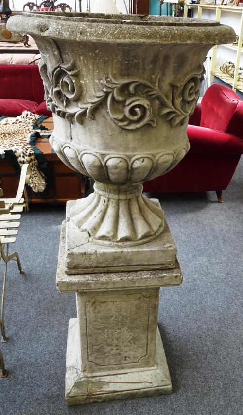 A large pair of reconstituted stone jardinières, each with relief scroll body and fluted socle, on stepped square base, 70cm diameter x 140cm high, (2