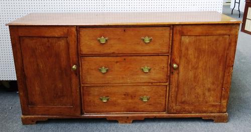 A 19th century pine dresser base, with three central drawers flanked by cupboard, on bracket feet, 186cm wide x 94cm high x 56cm deep.