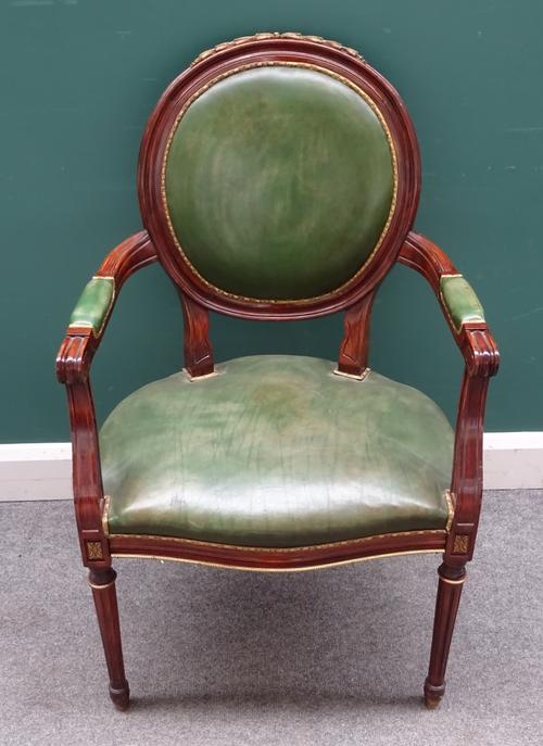 A Louis XVI style gilt metal mounted stained beech open armchair, with serpentine seat on tapering fluted supports, 62cm wide x 100cm high.