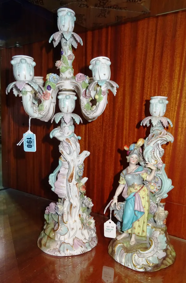 A pair of Potschappel five branch figural candelabra, late 19th century, each with opposing male and female warrior figures on a foliate scroll base,