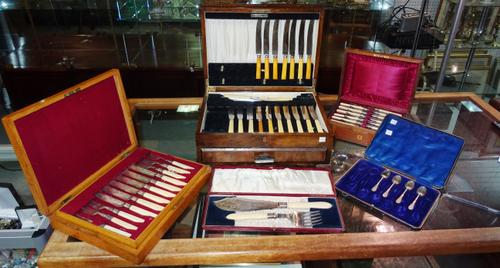 Plated wares, comprising; twelve pairs of fish knives and forks, with a wooden case, a pair of plated fish servers, cased, four plated coffee spoons w