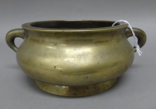 A Chinese bronze censer, six character Xuande mark but later, of compressed bombé form with loop handles, 18cm. wide across handles. Weight 1084 gms.