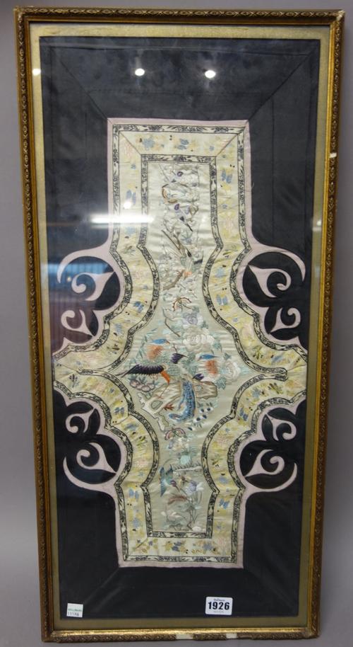 A Chinese embroidered sleeve panel, late 19th century, depicting pheasants and other birds in flowering branches, 50cm. by 28cm., framed and glazed.