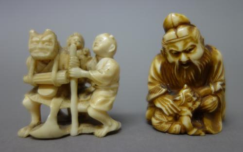 Two Japanese ivory netsuke, late19th/early 20th century, one carved as Shoki kneeling over a diminutive oni, 4cm. high; the other carved with an oni,
