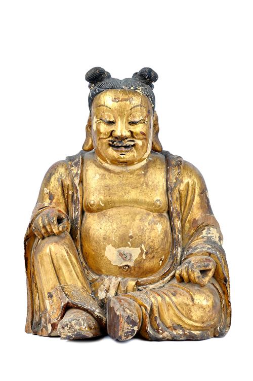 A large Chinese giltwood figure, 19th century, the corpulent character seated looking downwards with benevolent expression on his face, 46cm. high.  I
