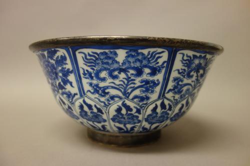 A Chinese blue and white bowl with later silver mounts, the porcelain Kangxi, the mounts Dutch, hallmark for 1857, the exterior painted with a band of