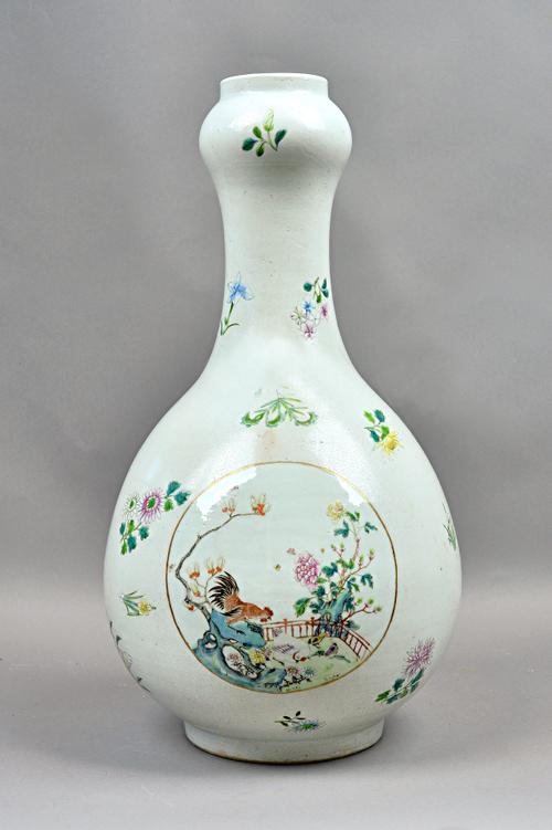A large Chinese porcelain sgraffito-ground famille-rose vase, probably early 19th century, of pear form with garlic mouth, painted with three panels o