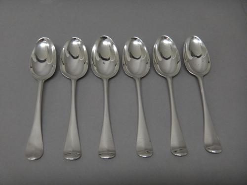 Six silver bottom marked Hanoverian pattern dessert spoons, comprising; five London 1762 and one uncertain, possibly London 1744, combined weight 214