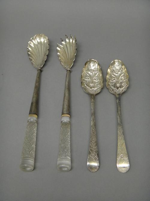 A pair of silver berry fruit serving spoons, having later floral and foliate embossed and engraved decoration, London 1782 and a pair of late Victoria