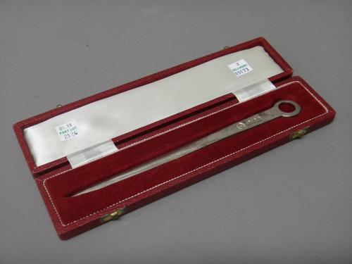 A silver letter opener, with a circular pierced terminal, Sheffield 1970, length 21.5cm, weight 58 gms, with a case.  After-sale
