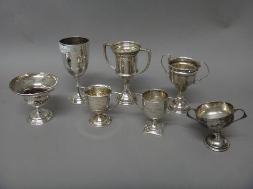 A group of seven silver trophy cups, (note: one with lead melted into the base), gross combined weight 485 gms, (7).