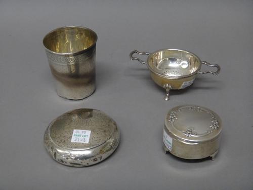 Silver and silver mounted wares, comprising; a circular tobacco box, Birmingham 1899, a twin handled tea strainer, with a stand and a circular hinge l