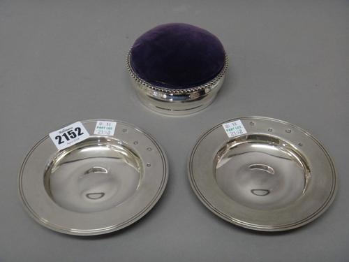 A silver mounted pin cushion box, of circular form, having a gadrooned rim, London 1905 and a pair of silver Armada style dishes, of circular form, di