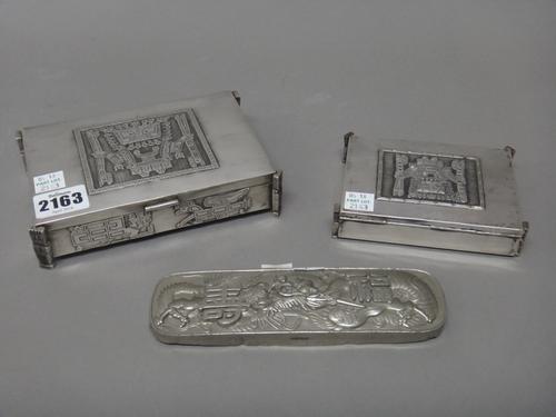 A rectangular hinge lidded box, possibly South American, decorated with mythological figures and animals and raised on four figure feet, another small